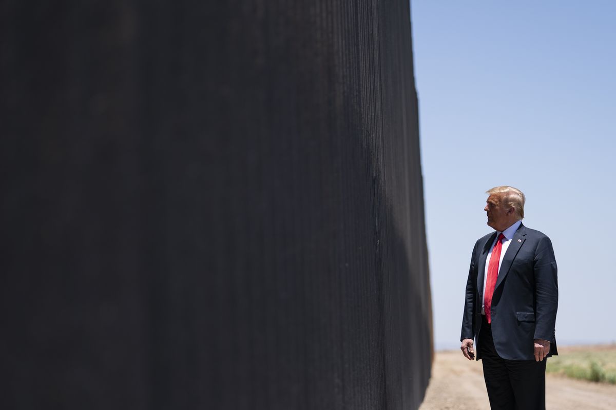 FILE - In this June 23, 2020, file photo, President Donald Trump tours a section of the border wall in San Luis, Ariz. During his 2016 primary run, Trump sought to mark his ground as a hard-line immigration enforcer who would build “a great, great wall on our southern border.” Nearly four years later, Trump still has work to do completing his wall and much that has been completed has been paid by U.S. taxpayers despite promises otherwise.  (Evan Vucci)