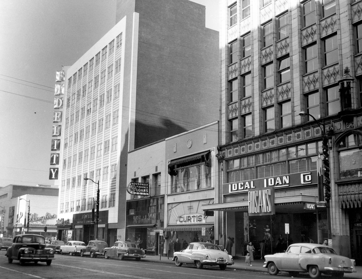 June 29, 1955: The north side of the 500 block of West Riverside Avenue featured, from left, the Fidelity Plaza building, the Hill Bros. building, the Spokane Hardware building and the Sherwood Building. The clothing stores, left to right from the Fidelity Plaza, are McBride’s womenswear, Curtis Style Shop menswear and womenswear, and Rusan’s womenswear.
