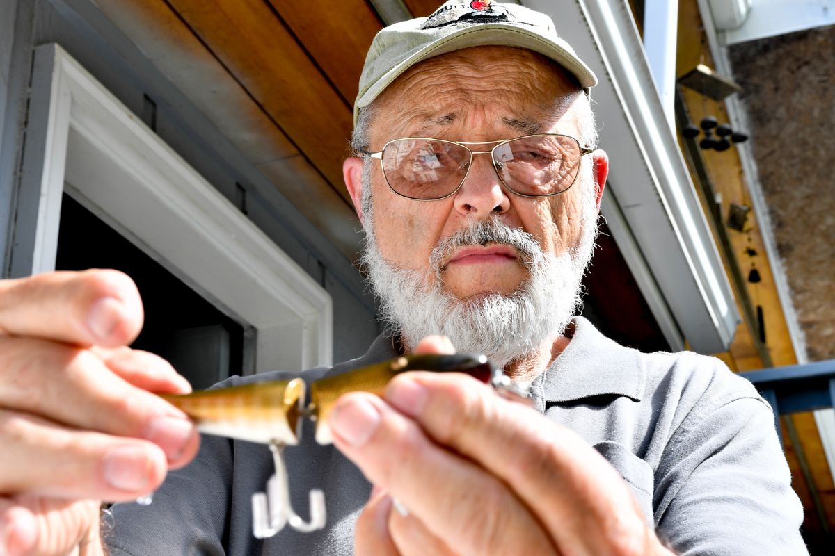 Gerald Hickman shows off a Creek Chub Jointed Pikie from his collection of fishing lures at his home in Cheney.  (Tyler Tjomsland/The Spokesman-Review)