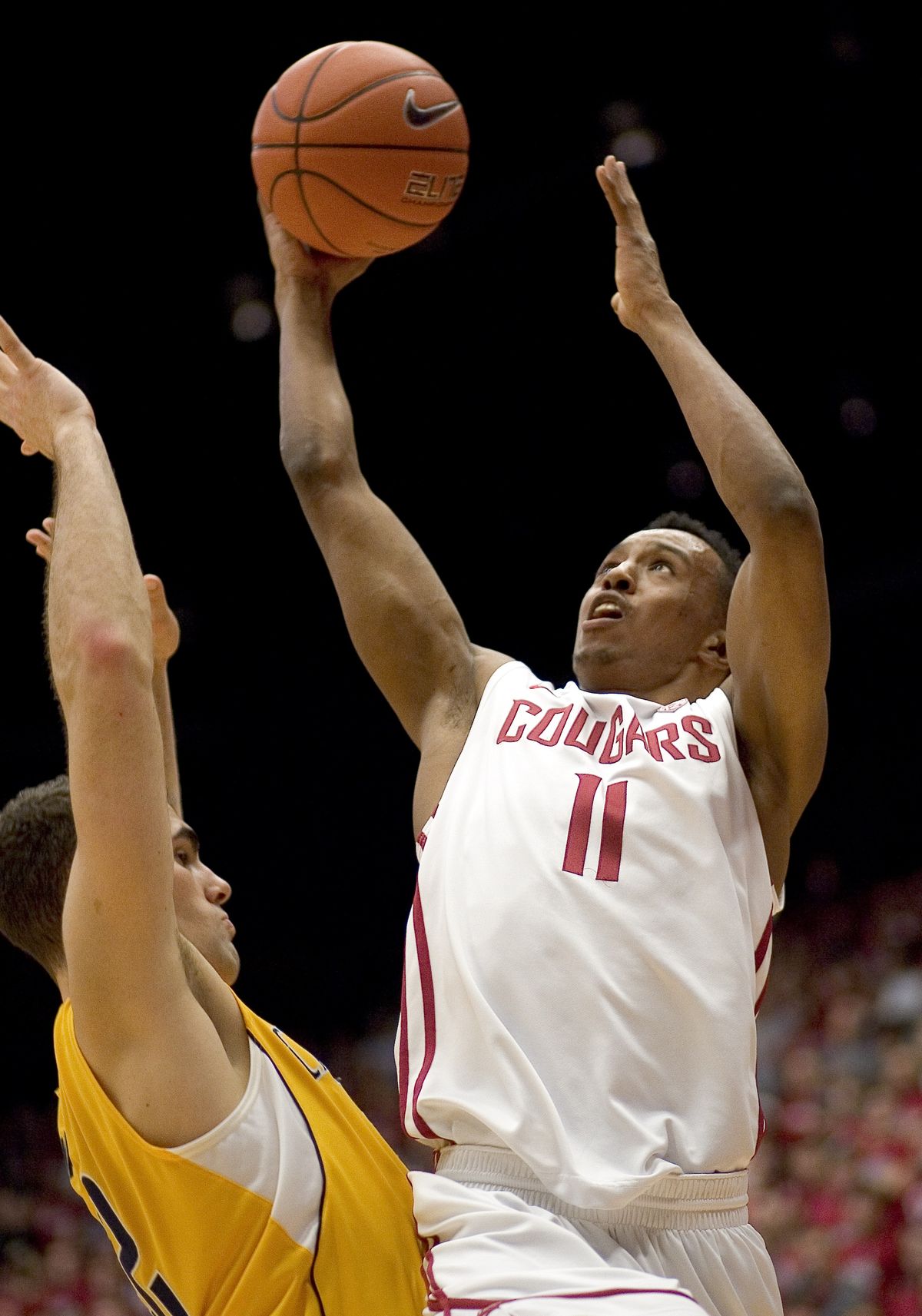 WSU’s Faisal Aden drives in for a layup over Cal’s Harper Kamp. Aden had a game-high 24 points. (Associated Press)