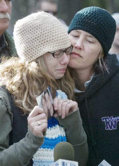 
Jaima Ritchey, left, is comforted by Ivy Green on Tuesday in White Pass, Wash., as she holds a photo of her sister, Hollie Rasberry, who died in the plane crash.  Green's brother Casey Craig also died in the crash. Associated Press
 (Associated Press / The Spokesman-Review)
