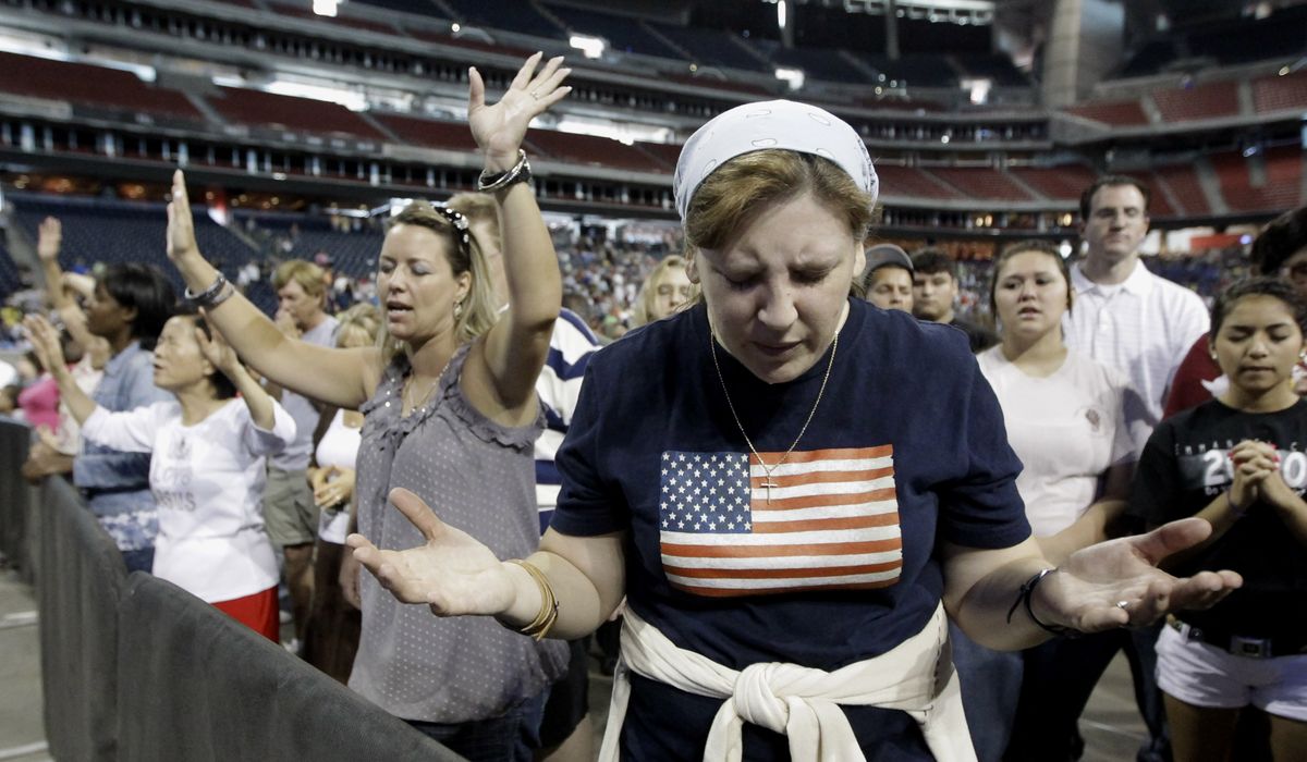 Lucy West, of Killeen, Texas, prays at The Response, a day of prayer, Saturday in Houston. Texas Gov. Rick Perry hosted the daylong prayer rally despite criticism that the event inappropriately mixed religion and politics. (Associated Press)