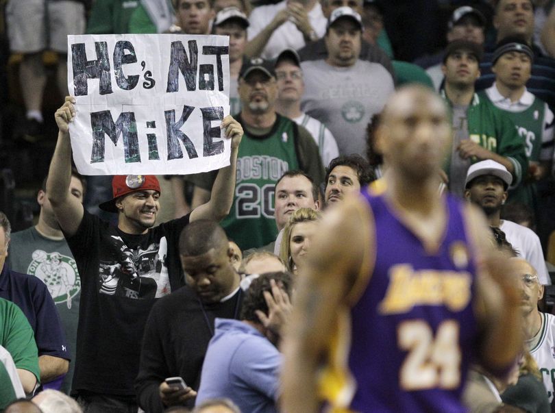 Los Angeles Lakers guard Kobe Bryant (24) walks up court as a fan holds a sign comparing Bryant unfavorably with Michael Jordan, during the fourth quarter in Game 5 of the NBA basketball finals against the Boston Celtics on Sunday, June 13, 2010, in Boston. The Celtics won 92-86 and lead the series 3-2. (Michael Dwyer / Associated Press)