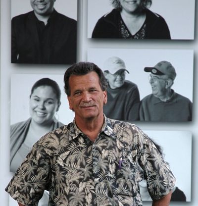 Free concert promoter Chris Guggemos of Handshake Productions poses for a photo in front of that wall of community movers and shakers that graced Sherman Square Park three years ago. (Duane Rasmussen, file photo)