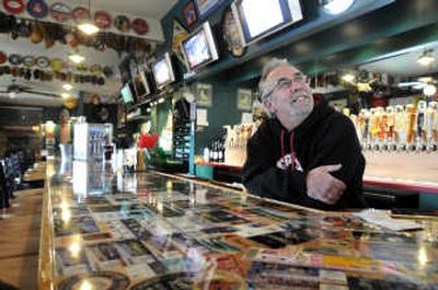 
Tom Capone, who owns Capone's Pub and Grill, looks around at his  new sports bar in Post Falls on Friday. Along with rebuilding the structure, which burned, he reconfigured the layout, upgraded kitchen fixtures,  and purchased dozens of pieces of sports memorabilia. 
 (Jesse Tinsley / The Spokesman-Review)