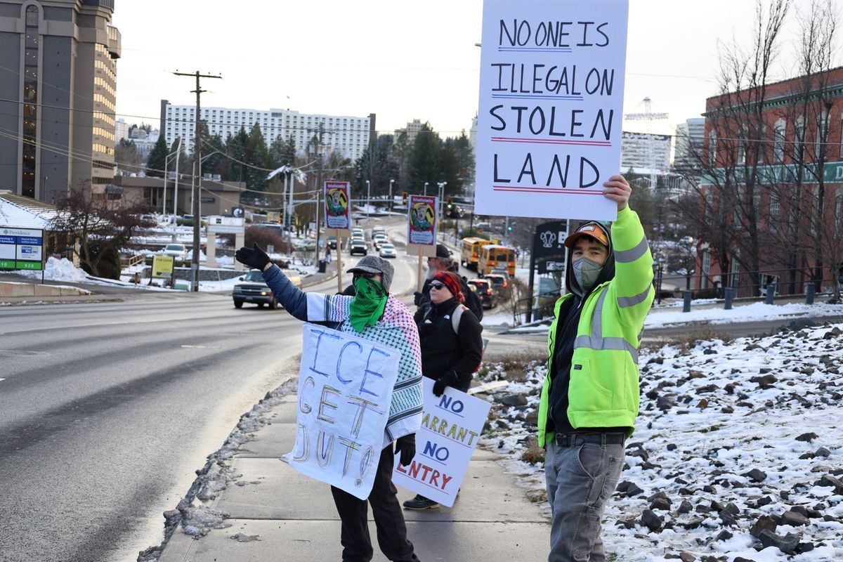 Protesters hold signs Friday outside of the Department of Homeland Security’s Spokane office. The protest sparked after Renee Good was killed by an ICE agent Wednesday in Minneapolis.  (Mathew Callaghan / The Spokesman-Review)