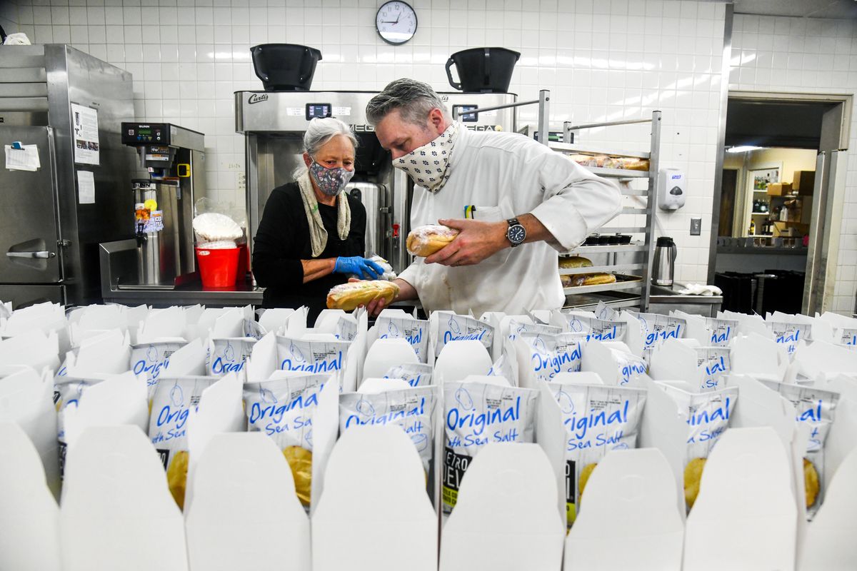 Mirabeau Park Hotel General Manager Andy Rooney, right, assists prep cook Janice Harrington as they race to fill an order of 105 sandwiches earlier this month in Spokane Valley. Rooney assists with many tasks throughout the hotel because of a shortage of workers.  (Dan Pelle/THE SPOKESMAN-REVIEW)