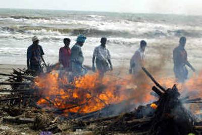 
Volunteers cremate bodies recovered from under debris at Nagapattinam, India, on Wednesday. The death toll in India from Sunday's earthquake-caused tsunamis is estimated at more than 4,400 people. 
 (Associated Press / The Spokesman-Review)