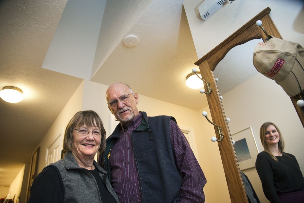 Linda Moulder and Jerry White are participating in a Washington State University project to equip homes with specialized computer sensors (including one directly above White) that will track motion and heat. Alyssa Weakley, right, is a WSU doctorate student working with the couple. (Dan Pelle)