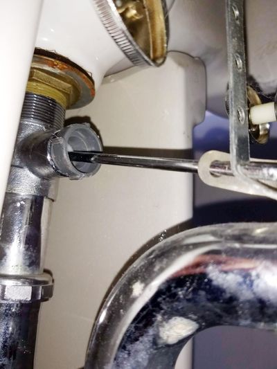 Put your head under your bathroom sink and this is what you’ll see. That horizontal chrome rod lifts the sink stopper up. (Tim Carter)