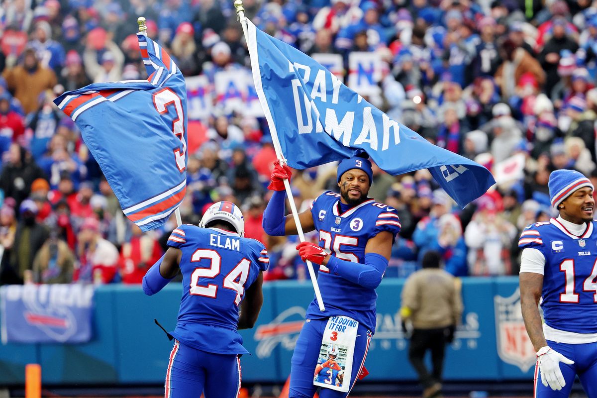 Taiwan Jones and Kaiir Elam of the Buffalo Bills wave flags in support of safety Damar Hamlin at Highmark Stadium prior to a game against the New England Patriots on Jan. 8 in Orchard Park, New York.  (Getty Images)