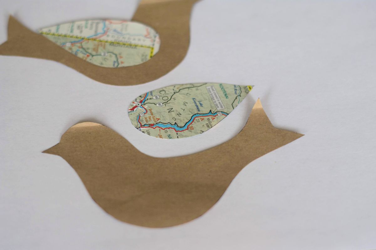 Trace and cut out a simple bird shape on a brown paper bag and a teardrop wing on a colorful paper scrap. (Katie Patterson Larson / For The Spokesman-Review)