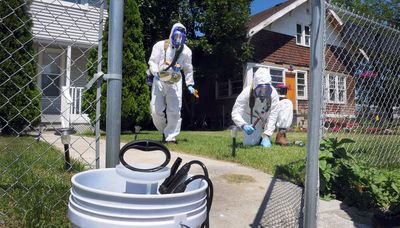 Chemist Raymond Wu, left, and EPA engineer Rob Pedersen take soil samples Tuesday from a yard  on West Sharp Avenue in Spokane. (CHRISTOPHER ANDERSON / The Spokesman-Review)