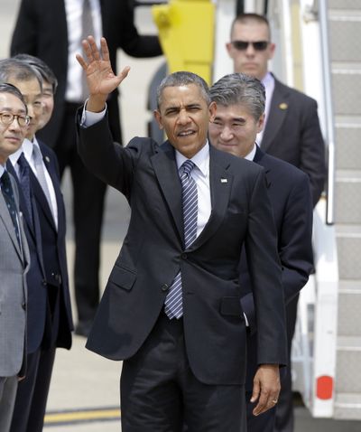 President Barack Obama waves upon his arrival in South Korea for a two-day visit. He touched down at Osan Air Base in Pyeongtaek, south of Seoul, today. (Associated Press)