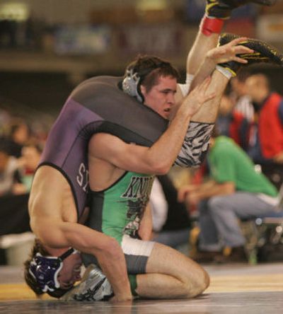 
Bryce Fisher of East Valley turns Patrick Simpson of Anacortes on his head, during the 145-pound class 3A quarterfinals at Mat Classic XVIII. 
 (Robert Sumner Special to the Spokesman-Review / The Spokesman-Review)