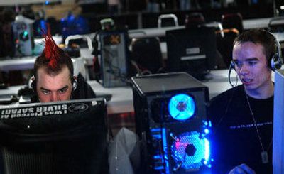 
Shawn Eller, left, 19, and his friend Derick McClure, 22, battle each other at the Spokane Gamefest on Friday at the Spokane Convention Center. The event included a Halo tournament, speeches on the gaming industry,  game stations and classic arcade games. 
 (Photos by Jed Conklin / The Spokesman-Review)