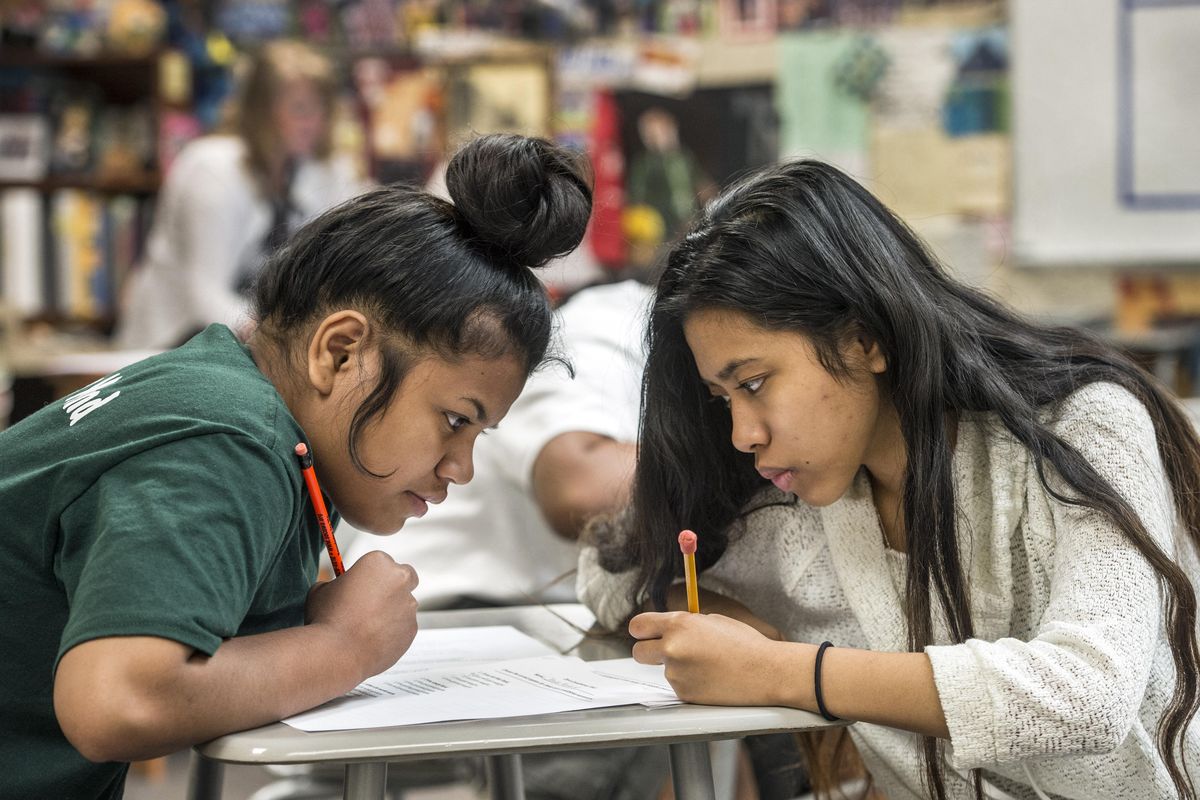 English Language Learner students Jetina Mojilong, left, and Peleise Abo work together during asummer school English class on July 7, 2016, at Mead High School. (Dan Pelle / The Spokesman-Review)