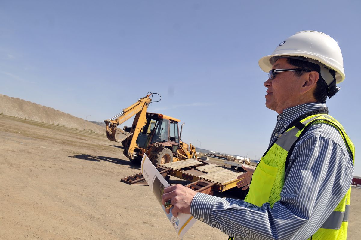 Bruce Katahira of SCAFCO Corp., a manufacturer of steel construction materials and grain storage equipment, walks across the former Playfair race track Wednesday. Katahira said he has fond memories of visiting Playfair as a child in the 1960s. (Jesse Tinsley)