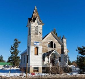 A Spirit Lake landmark, a church built in 1908, is currently on the market for $76,900. The owner has put a flag of Israel on the old church, generating intrigue. (Shawn Gust/Coeur d'Alene Press)