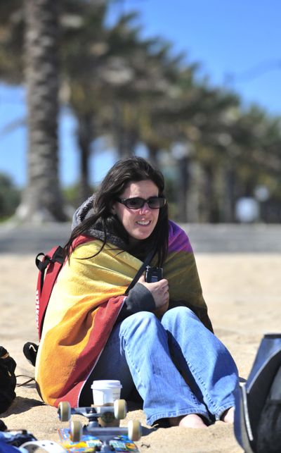 Sarah Jones, of Charlotte, N.C., tries to keep warm on Fort Lauderdale Beach on Thursday.  (Associated Press / The Spokesman-Review)