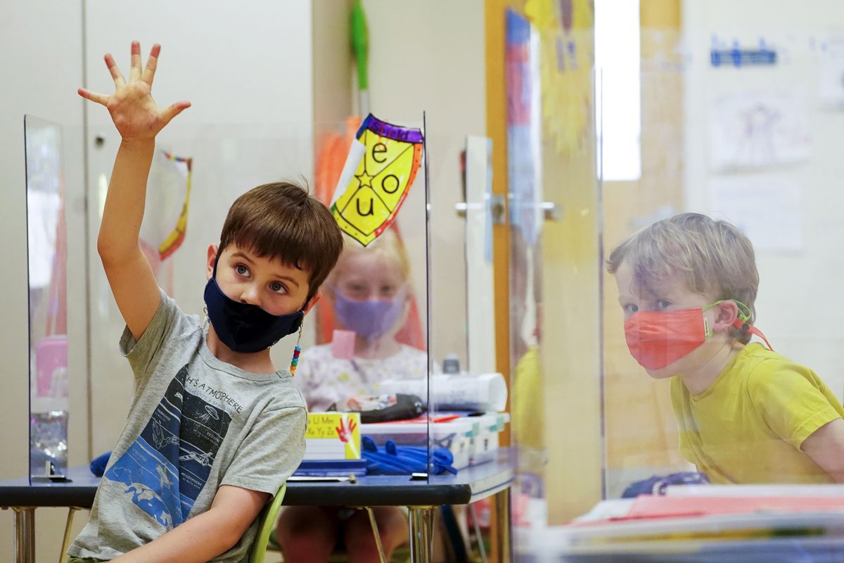 Kindergarten students wear masks and are separated by plexiglass during a math lesson on May 18 at the Milton Elementary School, in Rye, N.Y. School districts across the United States are hiring additional teachers in anticipation of what will be one of the largest kindergarten classes ever as enrollment rebounds following the pandemic.  (Mary Altaffer)