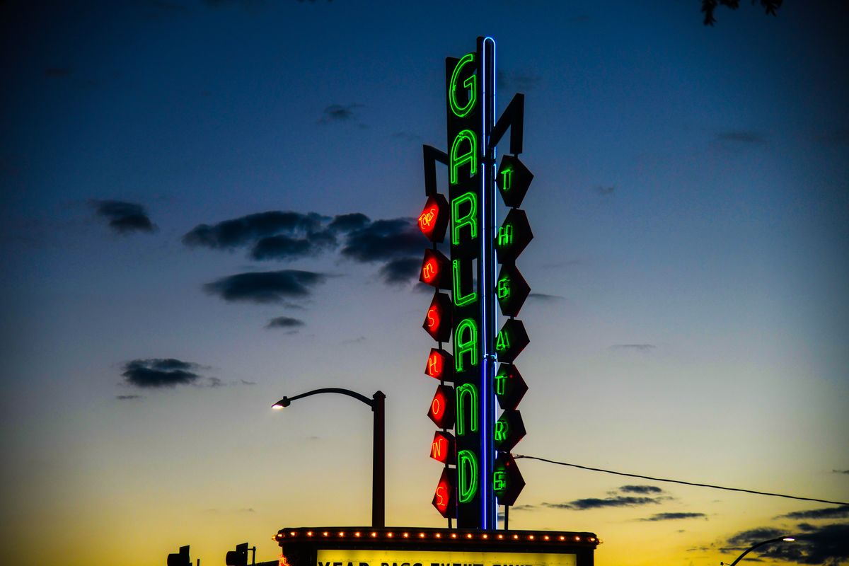 The Garland Theater’s marquee glows in the sky in December. The iconic business recently was sold to real estate developer Jordan Tampien.  (DAN PELLE/The Spokesman-Review)
