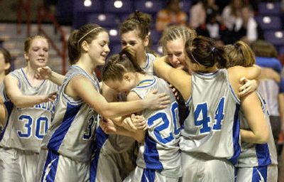 
La Salle Lightning players embrace on the court after defeating Curlew 54-38 in Saturday night's State B girls championship game at the Arena. 
 (Christopher Anderson / The Spokesman-Review)