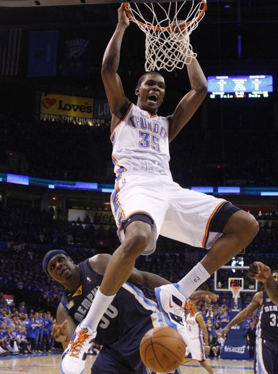Oklahoma City’s Kevin Durant dunks over Memphis’ Zach Randolph during the fourth quarter. (Associated Press)