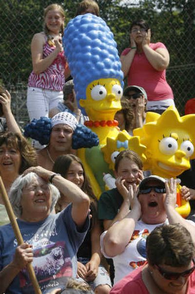 
Springfield, Vt., residents shoot a scene with Marge Simpson and Lisa Simpson props. The town is joining 13 other Springfields from across the nation in a contest, with the winner hosting the big-screen premiere of 