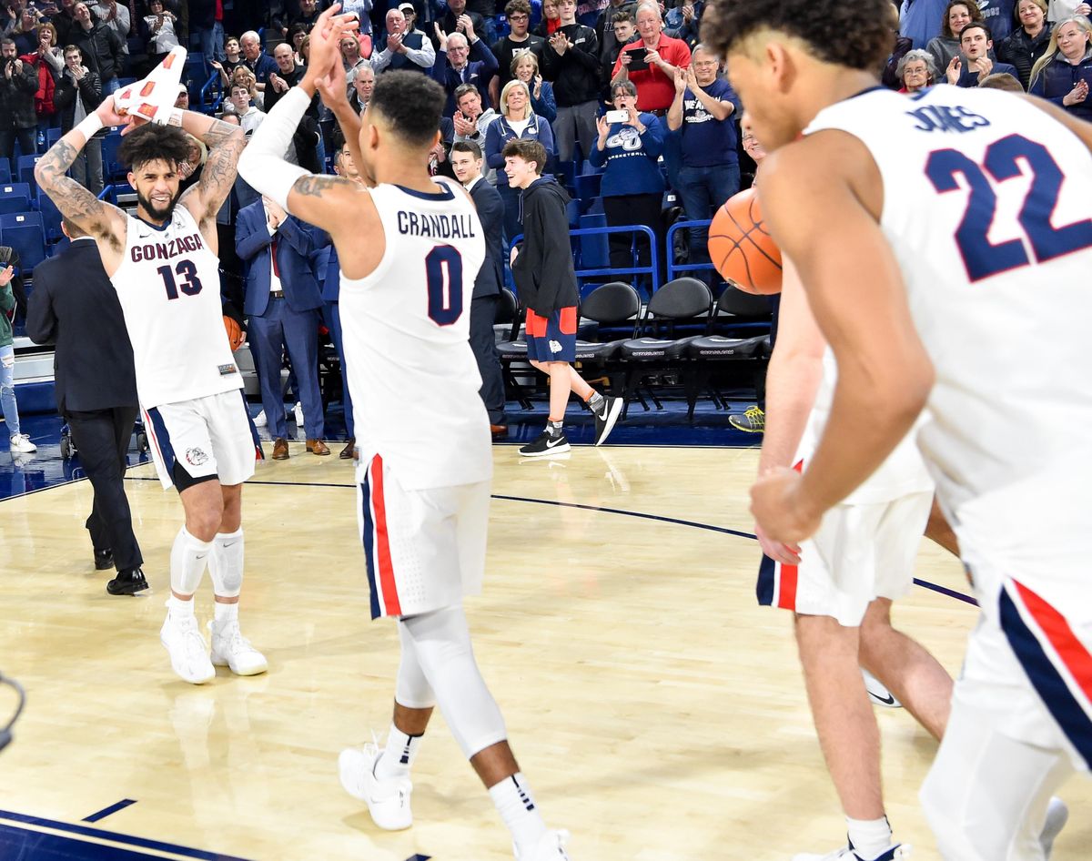 Gonzaga Bulldogs guard Josh Perkins (13) and guard Geno Crandall (0) celebrate defeating BYU during the second half of a college basketball game on Saturday, February 23, 2019, at McCarthey Athletic Center in Spokane, Wash. Gonzaga won the game 102-68. (Tyler Tjomsland / The Spokesman-Review)