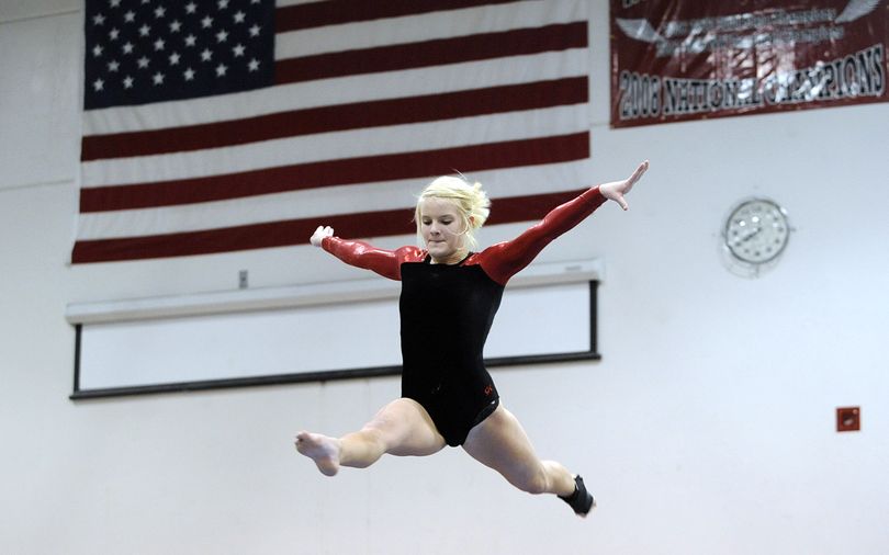 North Central’s Christy Grorud takes flight during her first-place effort on the balance beam. (Jesse Tinsley / The Spokesman-Review)