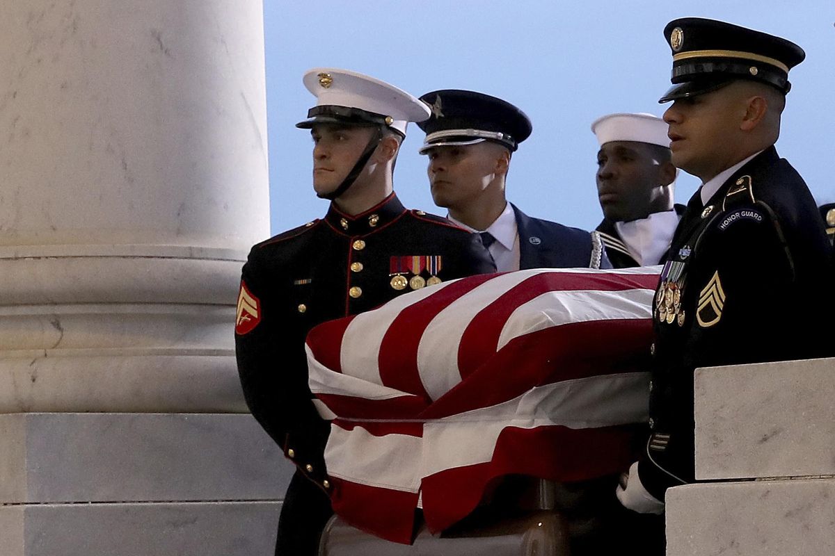 The flag-draped casket of former President George H.W. Bush is carried by a joint services military honor guard to lie in state in the rotunda of the U.S. Capitol, Monday, Dec. 3, 2018, in Washington. (Win McNamee / Associated Press)