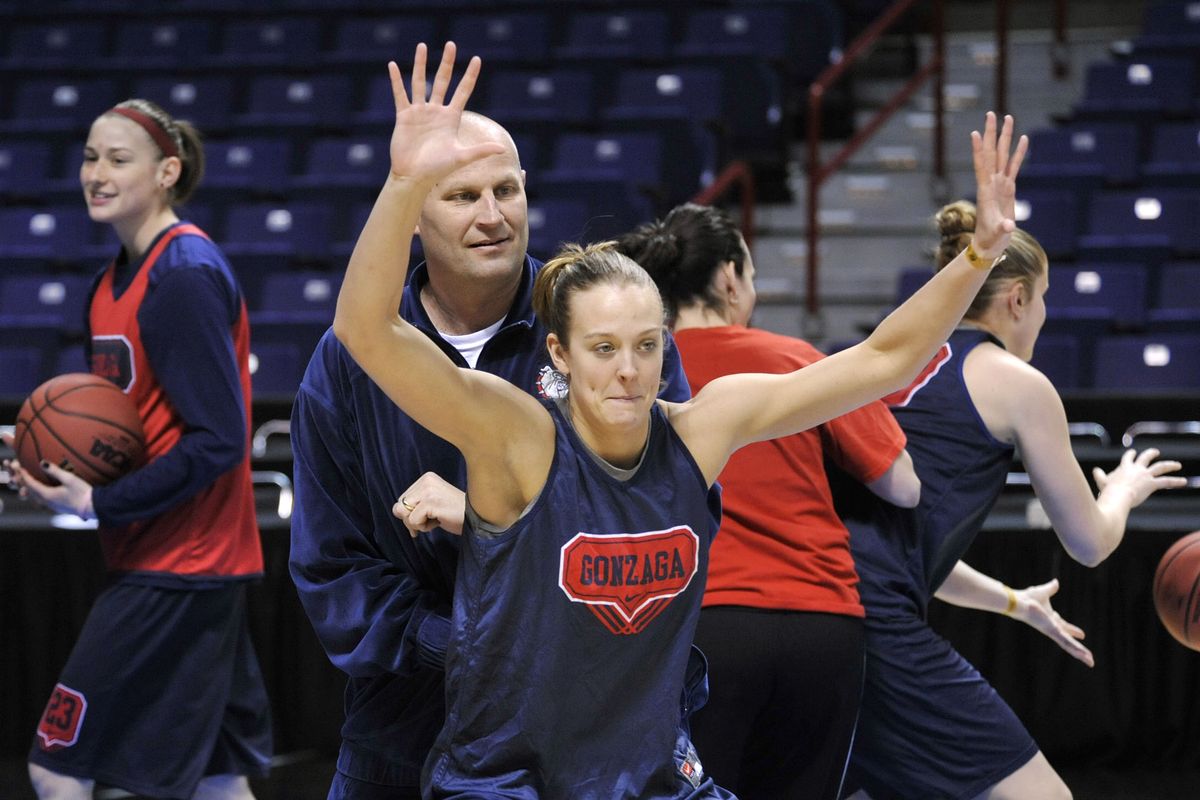 Gonzaga coach, Kelly Graves, plays defense on Claire Rapp during practice drills, March 25, 2011, in the Spokane Arena. (Dan Pelle / The Spokesman-Review)