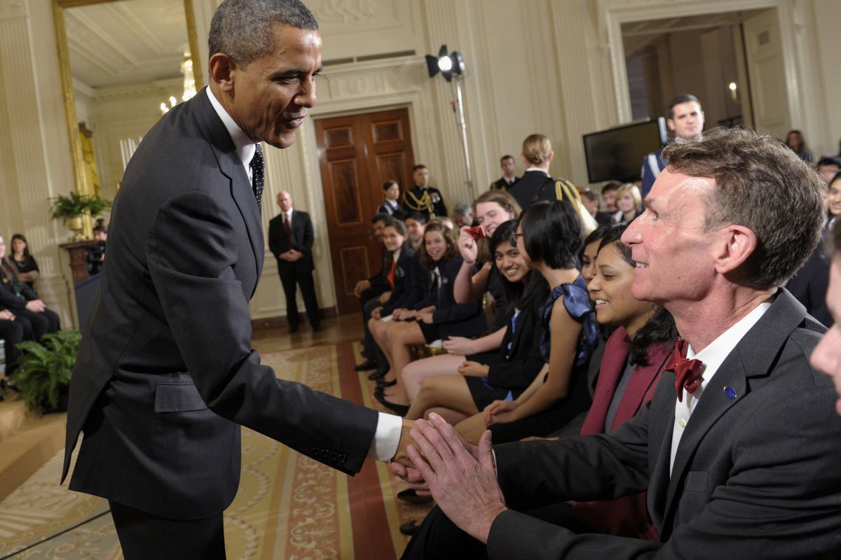 FILE - In this Feb. 7, 2012, file photo, President Barack Obama shakes hands with Bill Nye during an event in the East Room of the White House in Washington. Nye, a mechanical engineer and star of the popular 1990s Television show �Bill Nye The Science Guy,� recently waded into the evolution debate with an online video urging parents not to pass their religious-based doubts about evolution on to their children. (Susan Walsh / Associated Press)