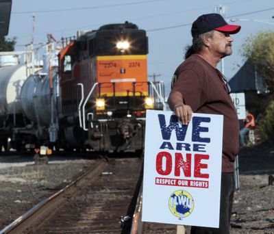 A man who refused to identify himself stands near the tracks as a pro-union crowd gathers in Vancouver, Wash., on Wednesday. (Associated Press)