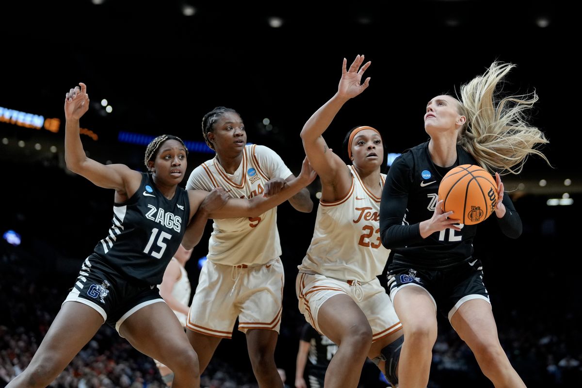 Gonzaga’s Eliza Hollingsworth drives to the hoop guarded by Texas’ Aaliyah Moore, while GU’s Yvonne Ejim battles for position against DeYona Gaston. The Longhorns limited the Zags to 27% shooting from the field and their lowest-scoring output of the season.  (Getty Images)