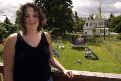 
Heather Davis stands on the back porch which she looks out onto her yard on South Collins Road. Davis was one of about six people who received a fake letter claiming it was from the Spokane Code Enforcement office. 
 (Liz Kishimoto / The Spokesman-Review)