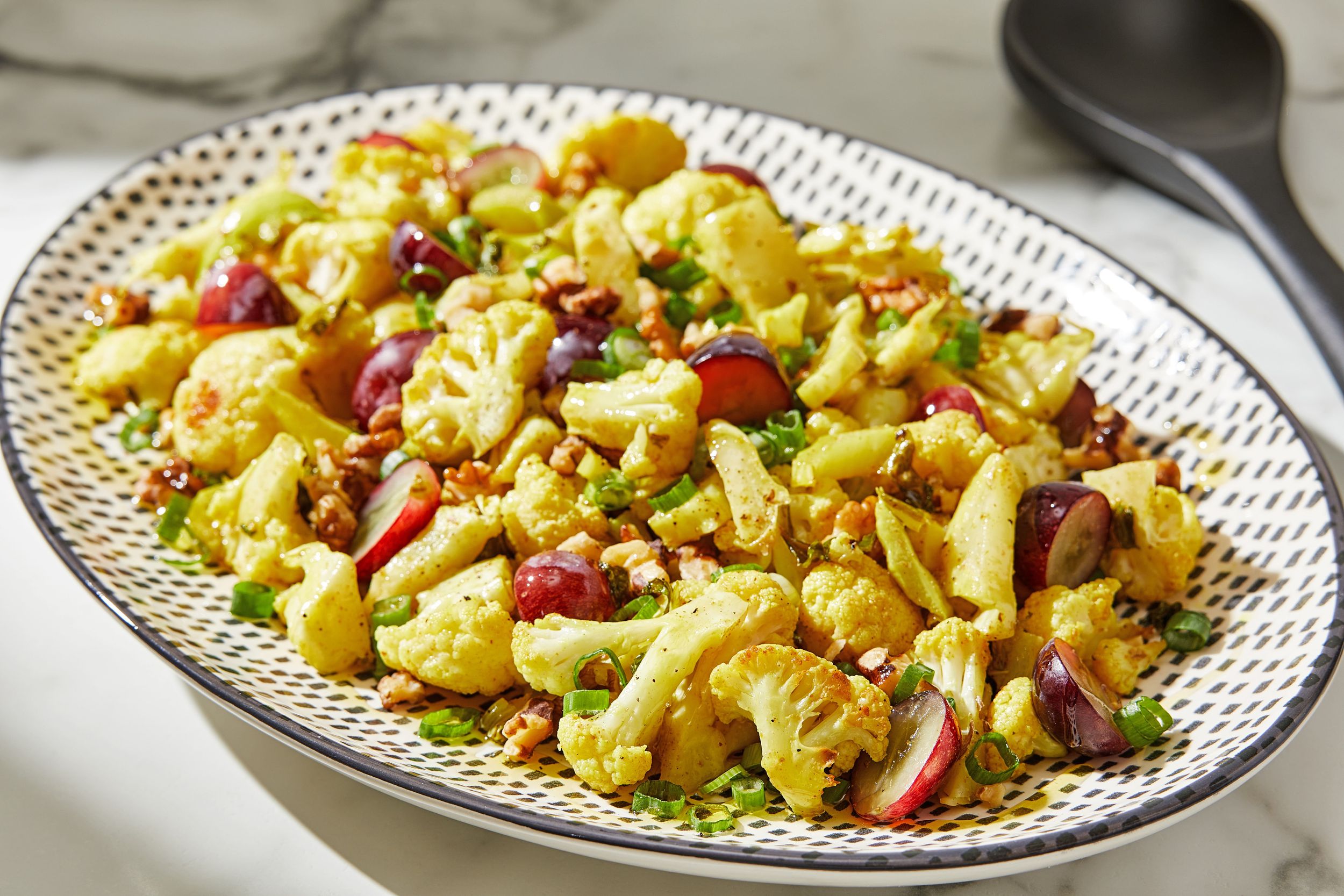 Curried cauliflower salad has crunchy walnuts and pops of sweetness