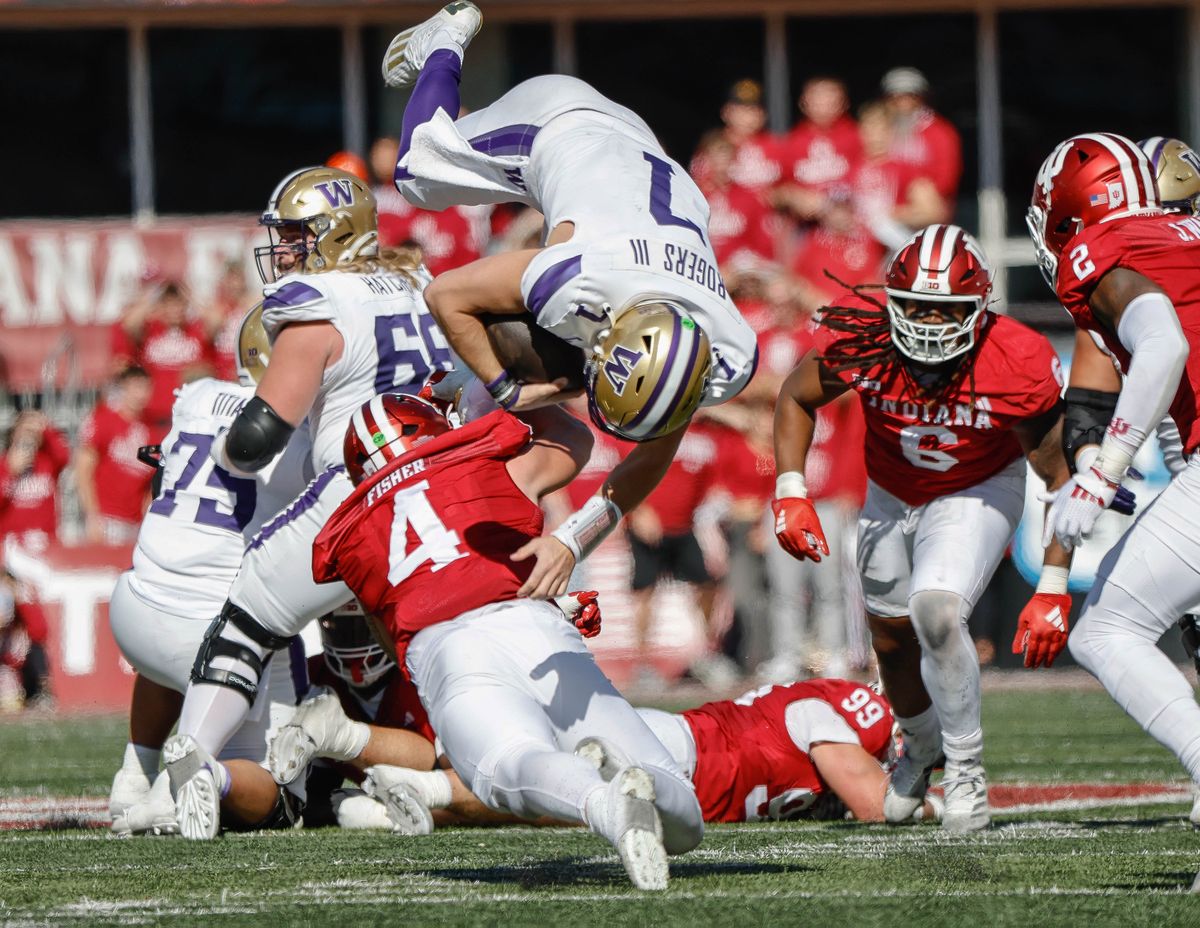 On 4th-and-3 in the second quarter, Washington quarterback Will Rogers tries to run for a first down run but is upended by Indiana linebacker Aiden Fisher short of the marker on Saturday at Memorial Stadium in Bloomington, Indiana.  (Dean Rutz/Seattle Times)