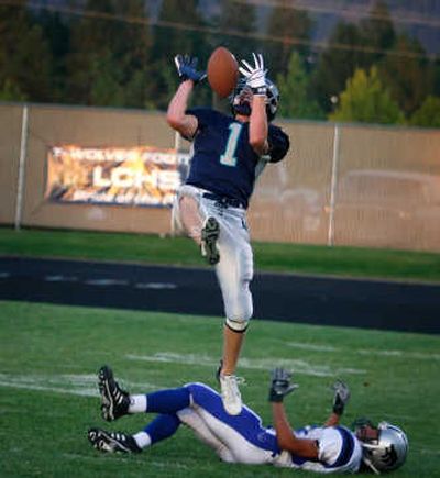 
Lake City's Kyle Johnson pulls in a long pass at the end of the first quarter over Timberline's Tre Gooding. Johnson caught five passes for 174 yards in Friday night's victory at home.Special to 
 (Bruce Twitchell Special to / The Spokesman-Review)