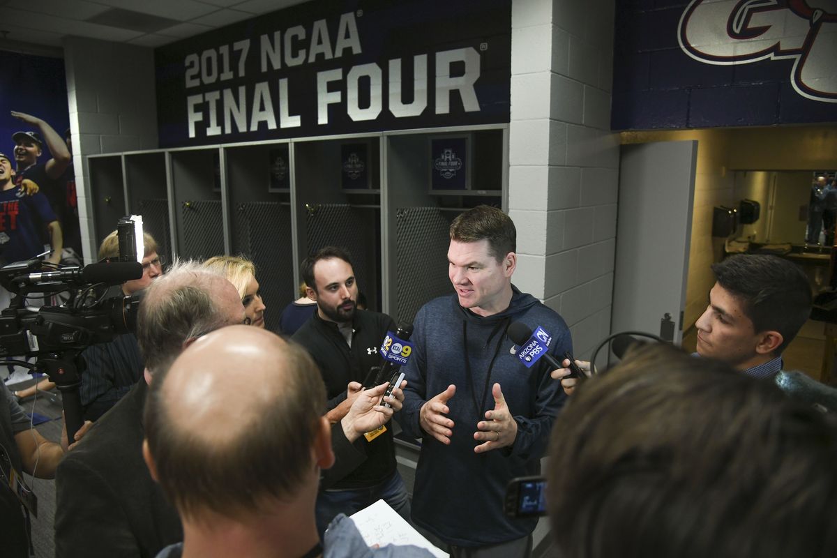 Gonzaga assistant coach Tommy Lloyd is surrounded by reporters, Sunday, April 2, 2017, in Phoenix.   (DAN PELLE/THE SPOKESMAN-REVIEW)