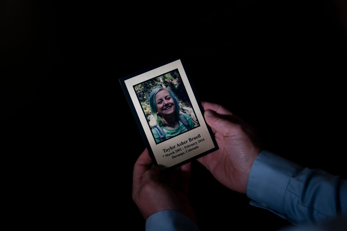 Harry Bruell holds a framed photo of his daughter, Taya, while sitting for a photo in his office in Santa Barbara, Calif., Wednesday, March 9, 2022. Taya killed herself when she was 14. Taya was a bright, precocious student who had started struggling with mental health issues at about 11, according to her father. At the time, the family lived in Boulder, Colorado where Taya was hospitalized at one point for psychiatric care but kept up the trappings of a model student.  (Jae C. Hong)
