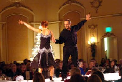 
Deborah Goetze and Steve Erickson take the runway for a spin, offering up a Latin dance number during the Christmas Tree Elegance fashion show. 
 (Jesse Tinsley / The Spokesman-Review)