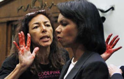 
War protester Desiree Ali-Fairooz, her hands painted red,  confronts Secretary of State Condoleezza Rice  on Wednesday. Associated Press
 (Associated Press / The Spokesman-Review)