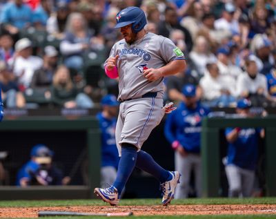 Toronto Blue Jays catcher Alejandro Kirk scores against the Seattle Mariners on Sunday at T-Mobile Park in Seattle. (Getty Images)