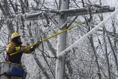 JC Zwick works on restoring power lines in Jaffrey, N.H., on Sunday. Three days after an ice storm hit the Northeast, hundreds of thousands of people were still without power.  (Associated Press / The Spokesman-Review)