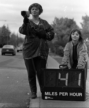 October 29, 1994. Roxanne Ryan and her daugher Patricia check speed of drivers along McDonald Road in Spokane Valley near the two elementary schools where traffic problems have been recurring. Roxanne has a handheld radar gun and a sign that registers the speed in the 20 mph school zone. (Steve Thompson)