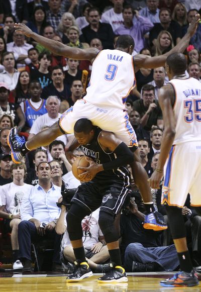 Serge Ibaka’s hard landing couldn’t hold down Dwyane Wade, who scored 19 points, or his Heat teammates. (Associated Press)