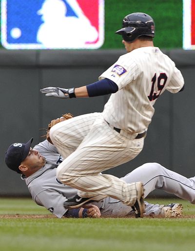 Mariners shortstop Luis Rodriguez makes the tag on Minnesota Twins’ Danny Valencia (19) in a 2011 game. The journeyman Valencia has been acquired by the Mariners in a trade with Oakland. (File Associated Press)