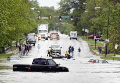 
Rescuers use boats and personal watercraft Monday in Topeka.
 (Associated Press / The Spokesman-Review)